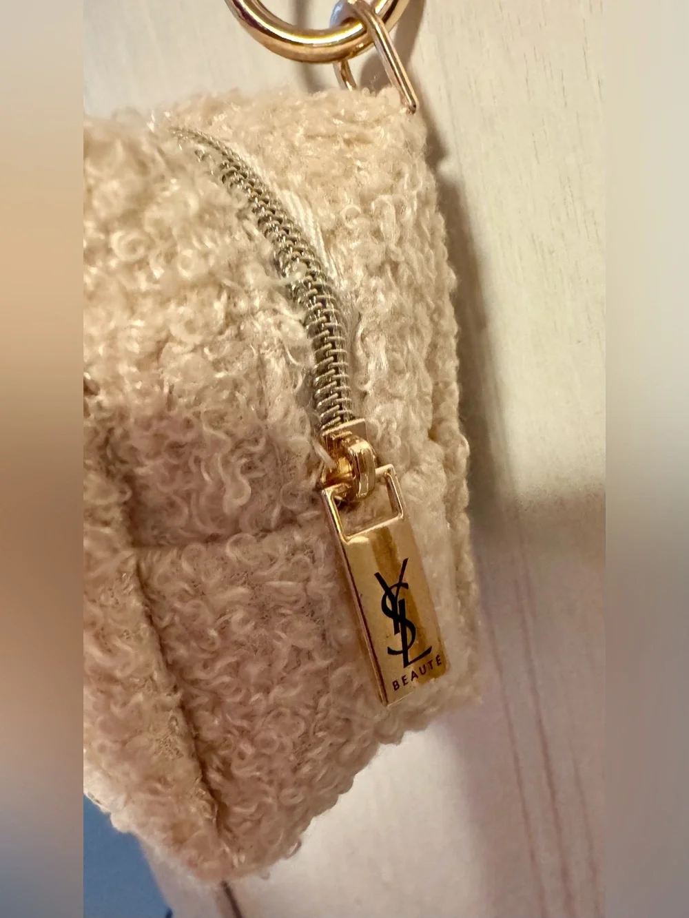 Yves Saint Laurent beaute Cream shearling pouch with gold hardware